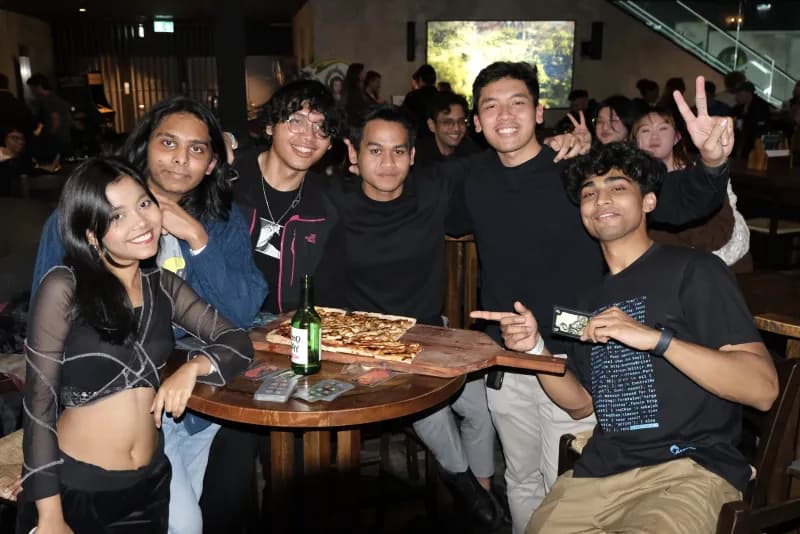 WIRED members around a pizza at a social event